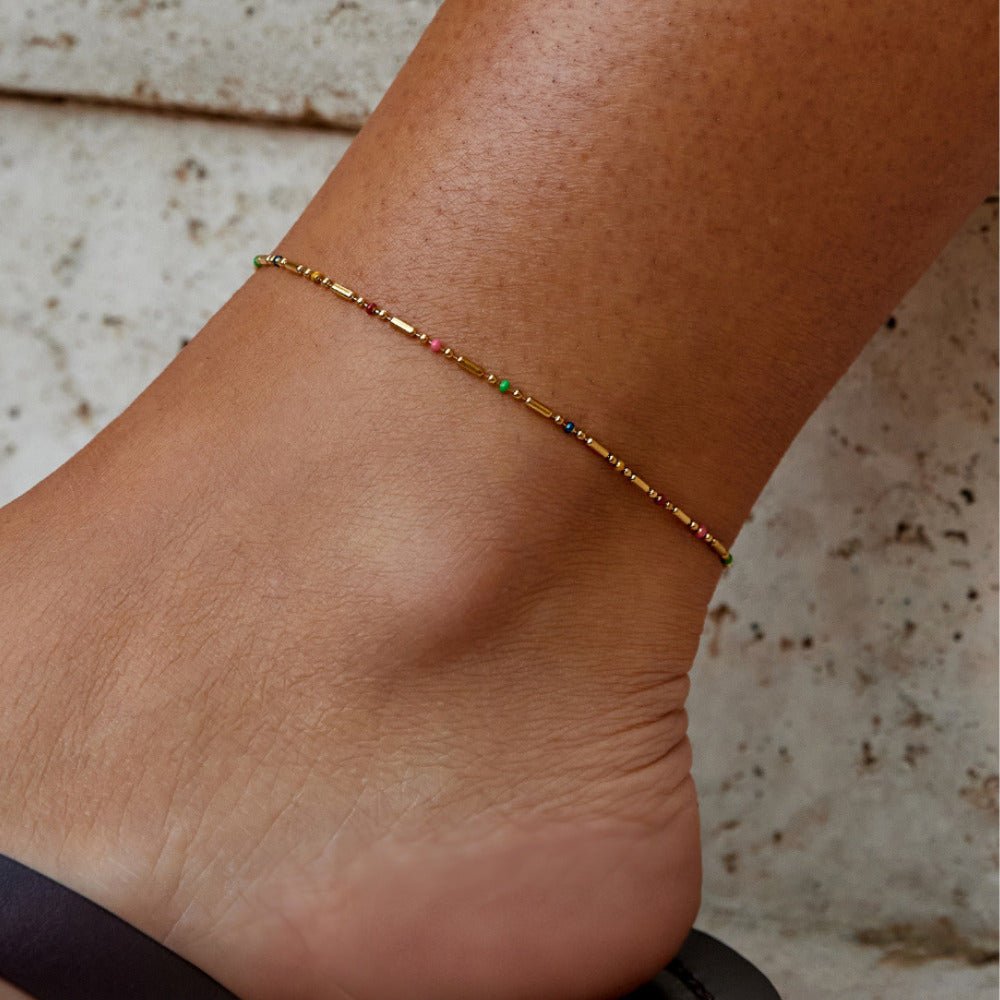 Rainbow Bead Anklet, worn on an ankle with gold bars and small coloured beads