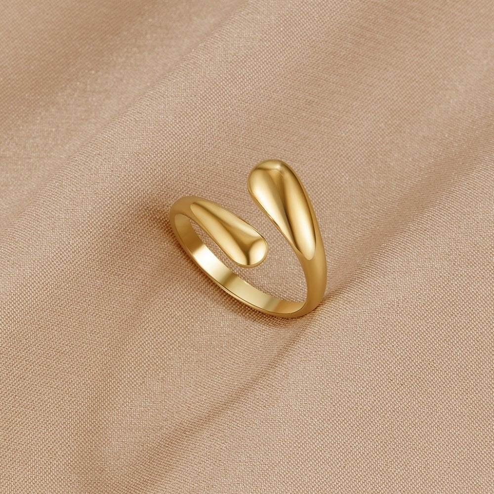 Raven Gold Wrap Ring, gold open wrap ring with teardrop ends on beige fabric