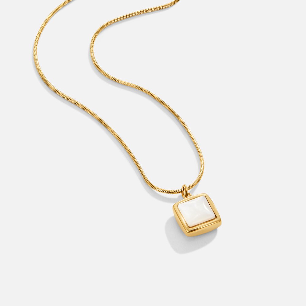 Riva Moonstone Pendant Necklace, gold snake chain necklace laid flat with square white pendant