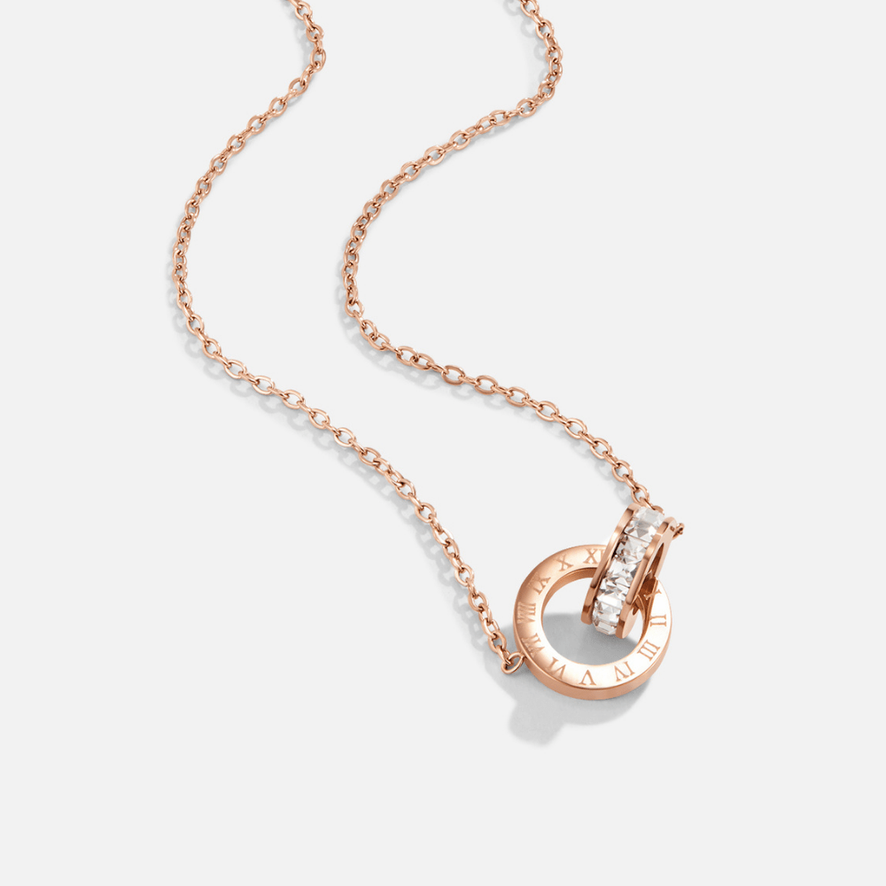 Rose Gold Infinity Necklace, laid flat on white, rose gold chain with a pendant of two rings