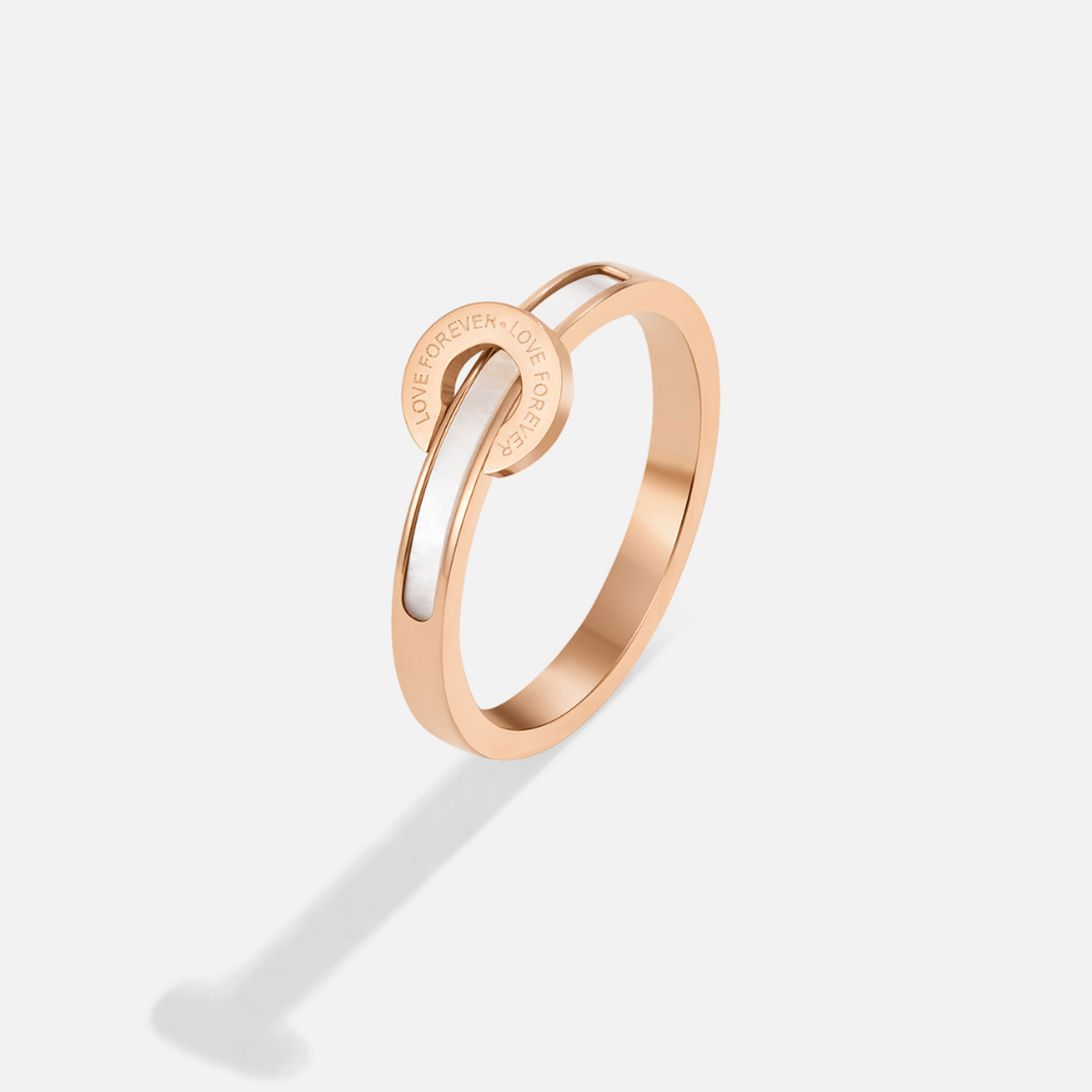 Rose Gold Infinity Ring, rose gold band with white inlay and engraved circle, on white background