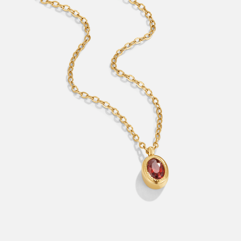 Ruby Red Crystal Necklace, gold chain necklace with oval red stone pendant on white background