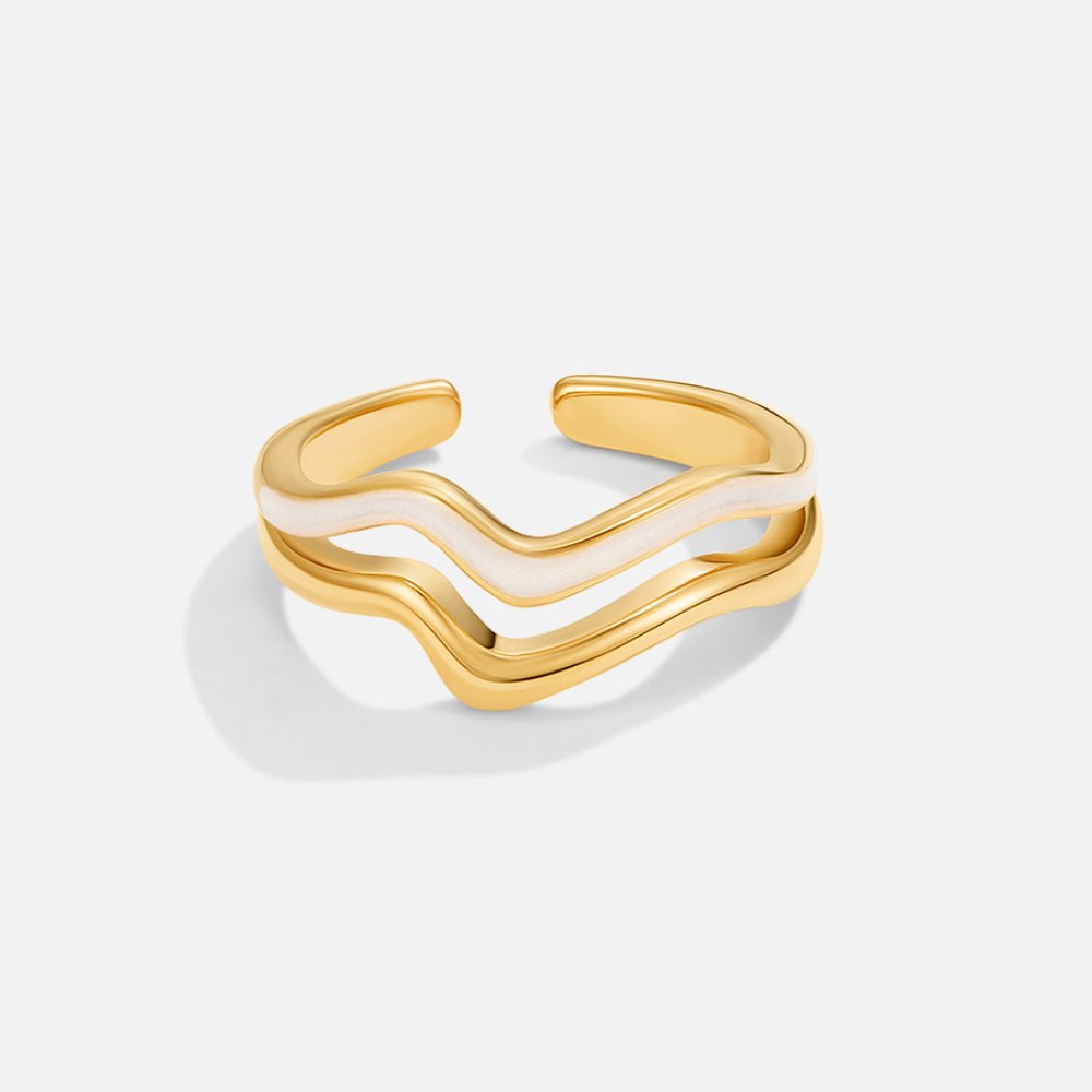 Savannah Ring, standing alone on white, gold ring with wavy band and cream enamel stripe