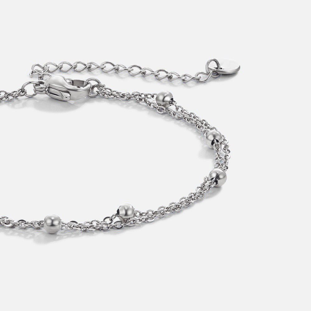 Silver Gaia Layered Bracelet, laid flat on white, close-up of double chain with silver beads