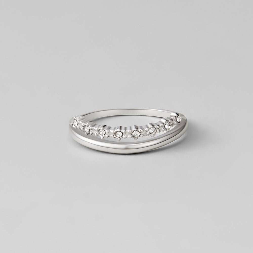 Silver Marissa White Crystal Layered Ring, ring lying flat on grey surface, curved band with
