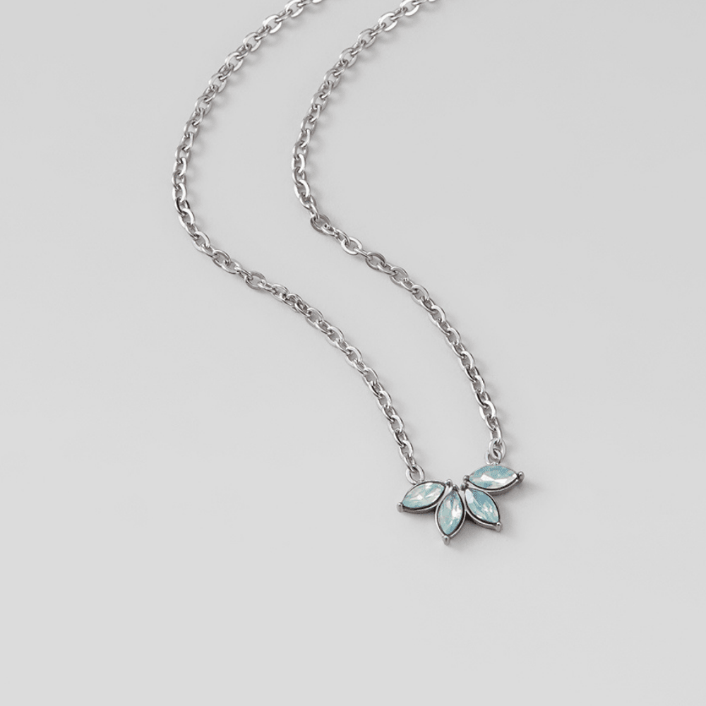 Silver Marquise Petal Necklace, laid flat on grey surface, pale blue marquise-stone pendant on
