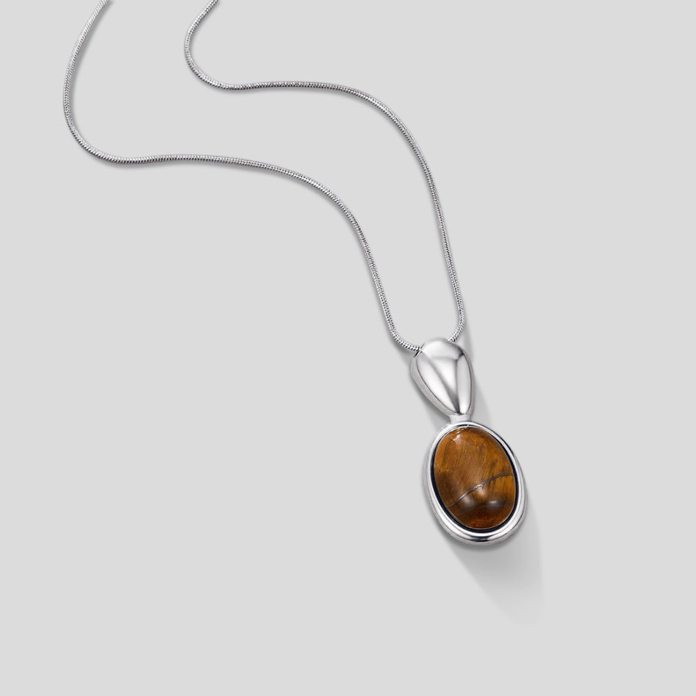 Silver Tiger Eye Stone Long Necklace, laid out on a light grey surface, pendant with amber stone