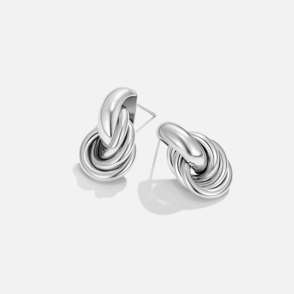 Sofia Twisted Silver Hoop Earrings, pair of polished silver knot earrings on white background
