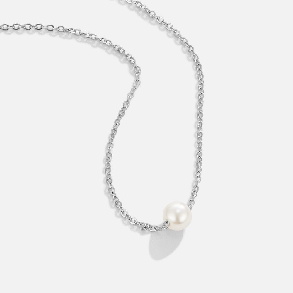 Solitaire Silver Pearl Necklace, silver chain necklace laid flat with a single white pearl