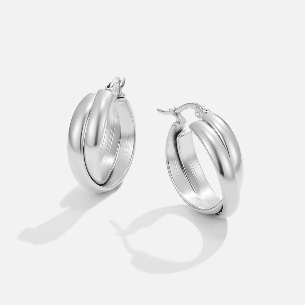 Talia Silver Hoop Earrings, pair of polished silver hoops on white background, angled view