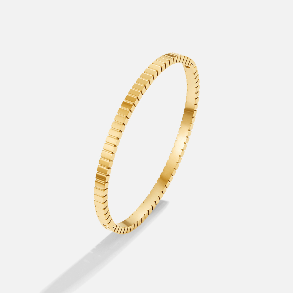 Tara Gold Bangle, standalone gold bangle on a white background, notched ridged edge