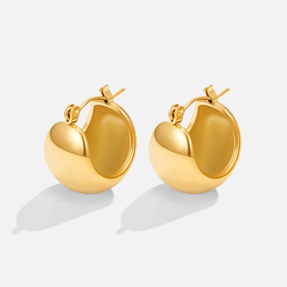 Tara Gold Chunky Hoop Earrings, a pair of polished gold chunky hoops on a plain light background