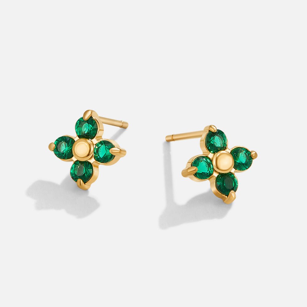 Tiny Emerald Petal Stud Earrings, a pair of gold stud earrings with four green stones each, on