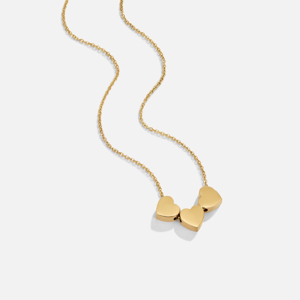 Trio Heart Pendant Necklace, gold chain necklace with three small heart charms on white background