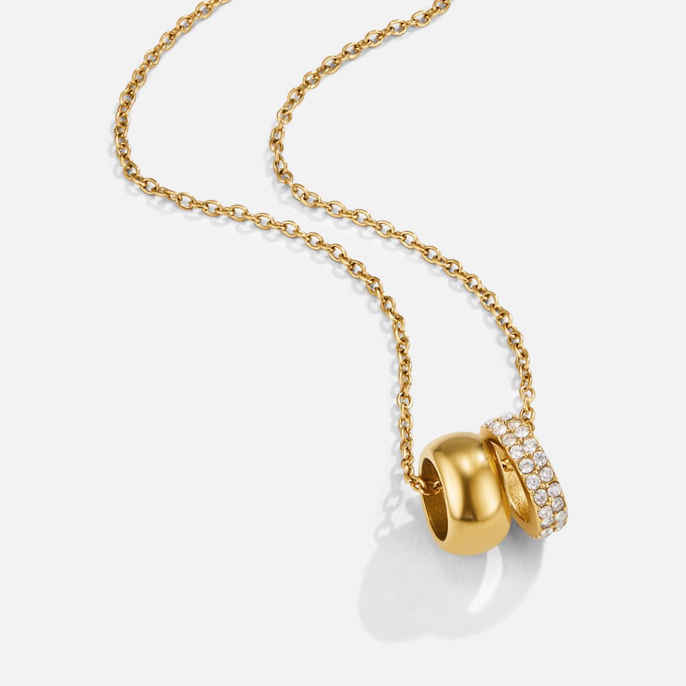Twin Gold & Crystal Ring Pendant Necklace, gold chain laid diagonally with two linked rings pendant