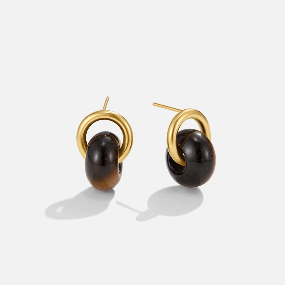 Twisted Amber Gold Earrings, pair of gold hoop earrings with dark brown stone drops, on white