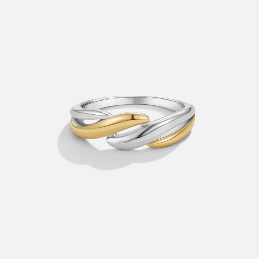 Twisted Ella Two-Toned Ring, ring on a plain light background, silver and gold bands crossing