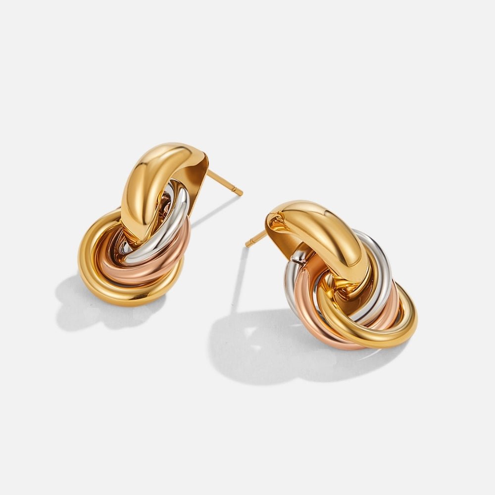 Twisted Three-Toned Hoop Earrings, a pair of knotted earrings on white, gold, and rose-gold rings