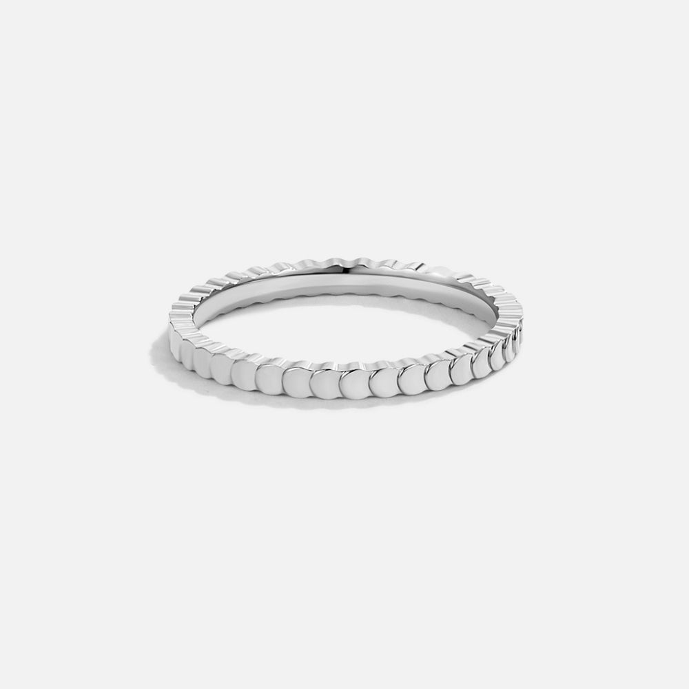 Vera Silver Ring, standing upright on plain light grey background, polished silver band with