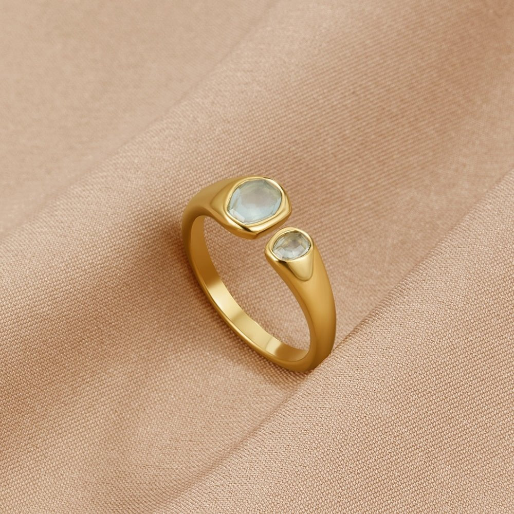 Vintage Aquamarine Wrap Ring, open gold ring with two pale blue stones on beige fabric
