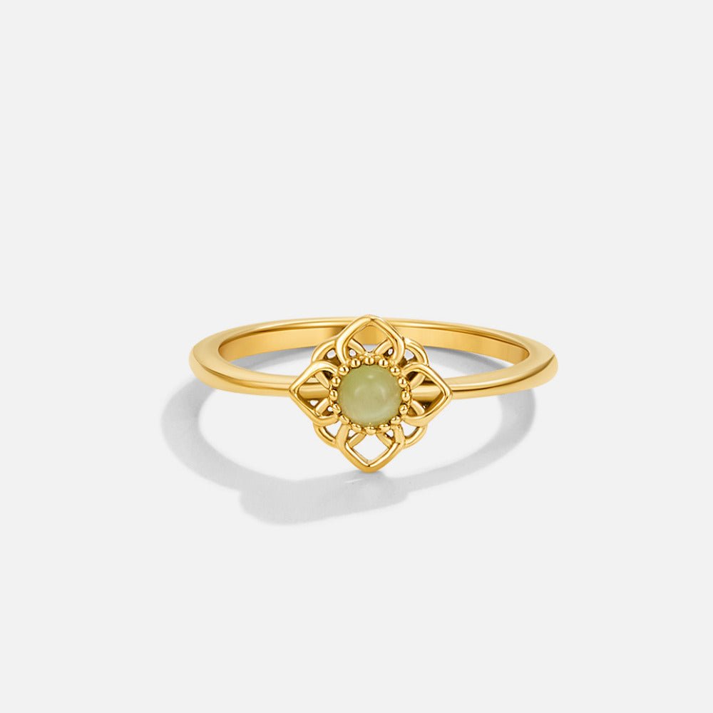 Vintage Lotus Flower Opal Ring, gold ring with openwork flower setting and pale green stone, on white background