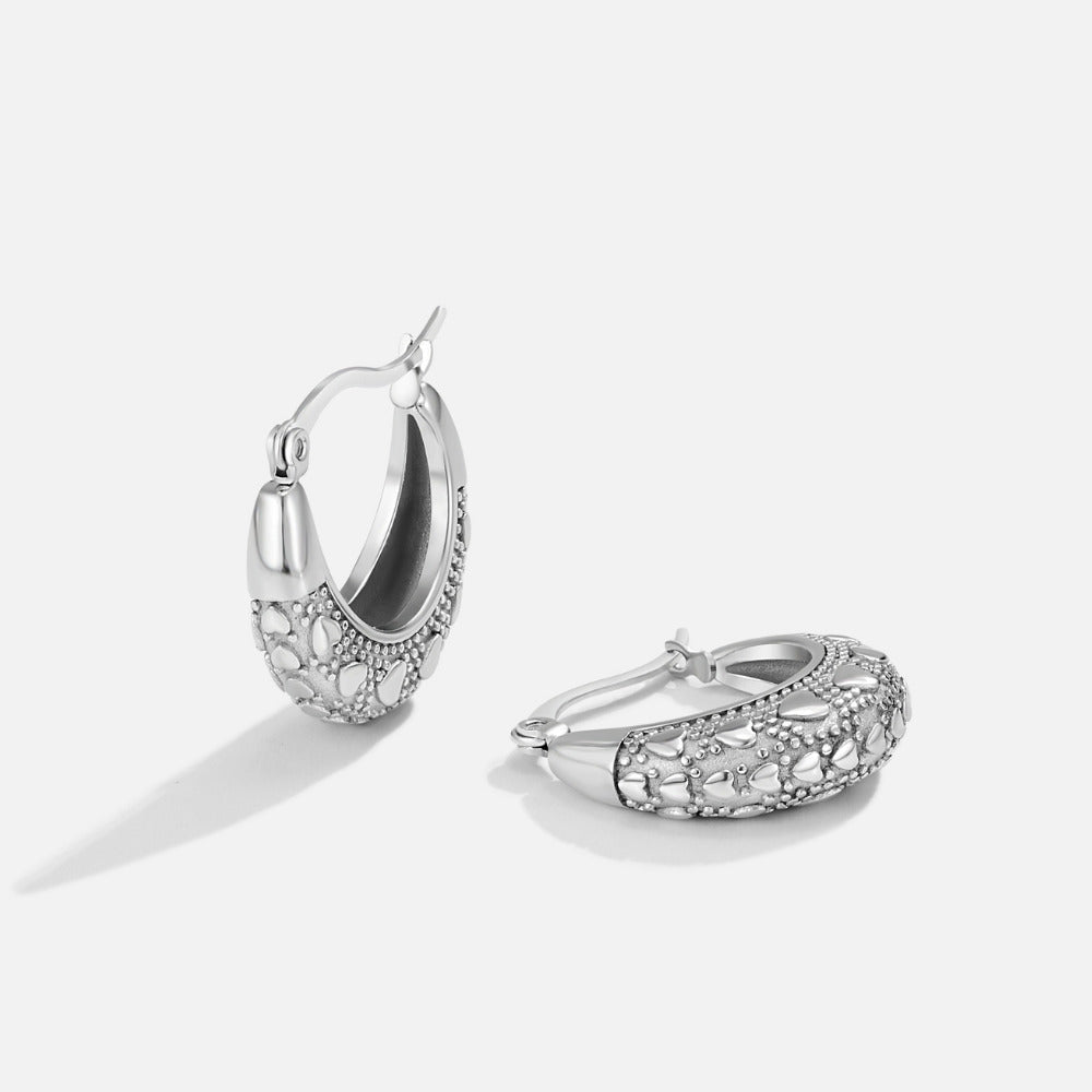 Vintage Silver Cleofe Earrings, pair of silver hoop earrings on white background, textured