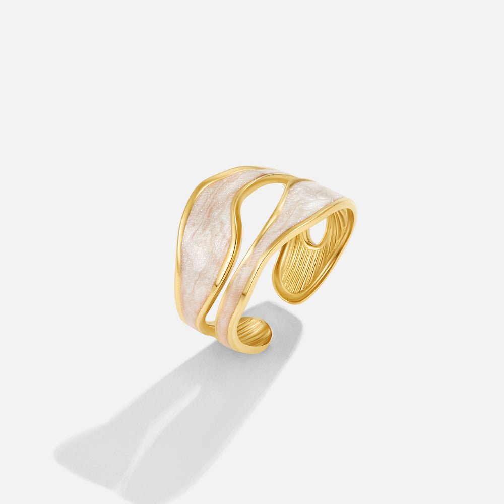 Wave Sahara Gold Ring, open gold ring with wavy cream enamel bands, standing on a light background