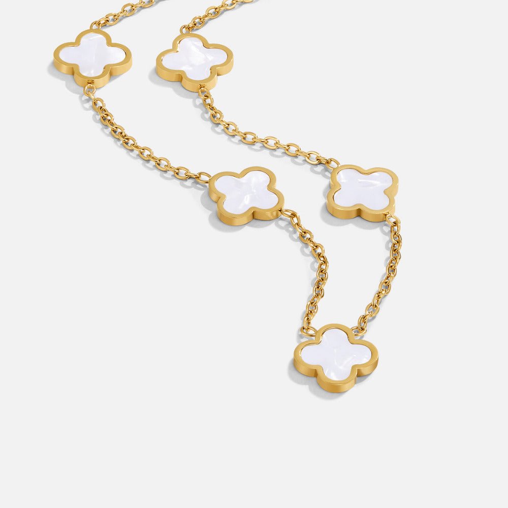 White Clover Cluster Necklace, gold chain with white mother-of-pearl clover motifs on white