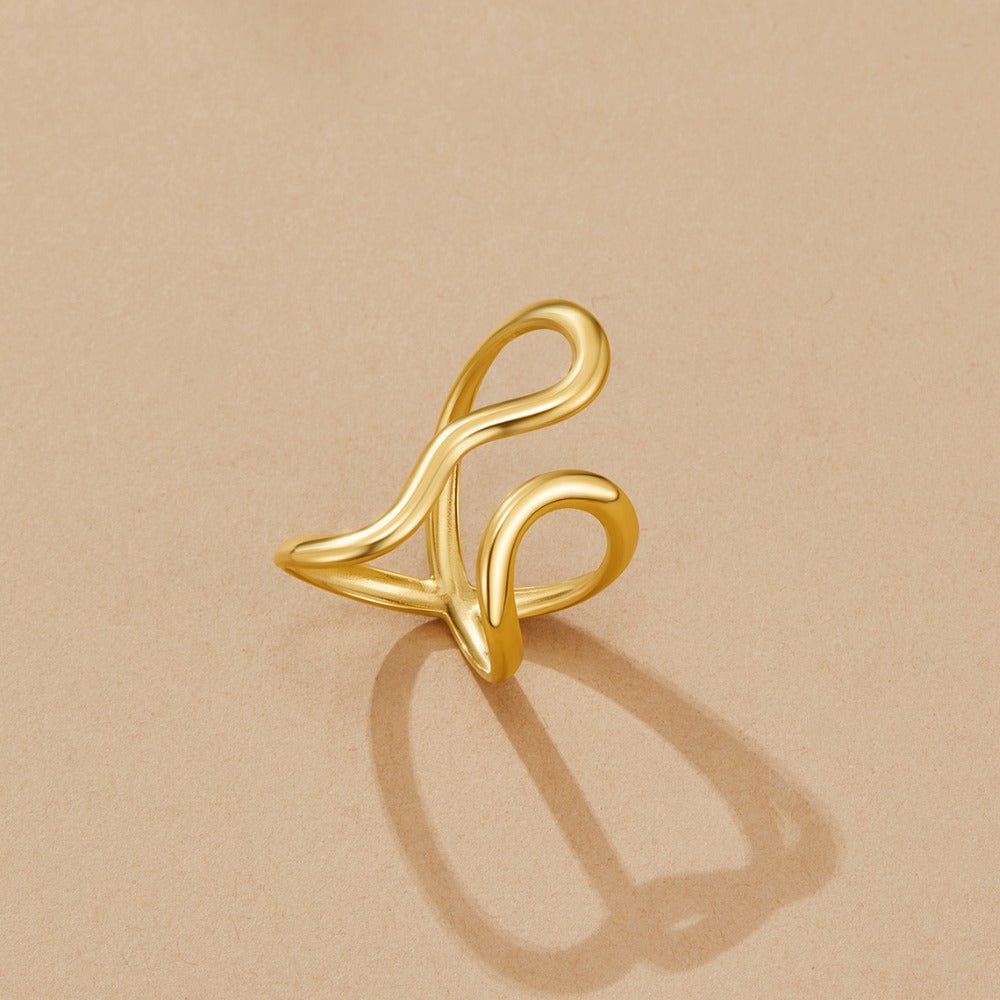 Yana Geometric Twist Ring, gold ring with a looping, twisted open design on beige