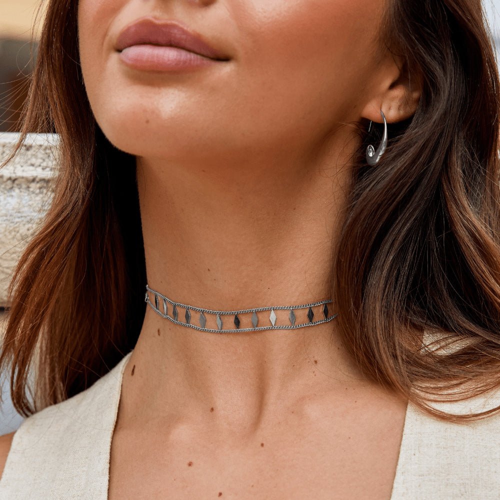 Zara Silver Choker, worn as a choker on a neck, with a silver hoop earring