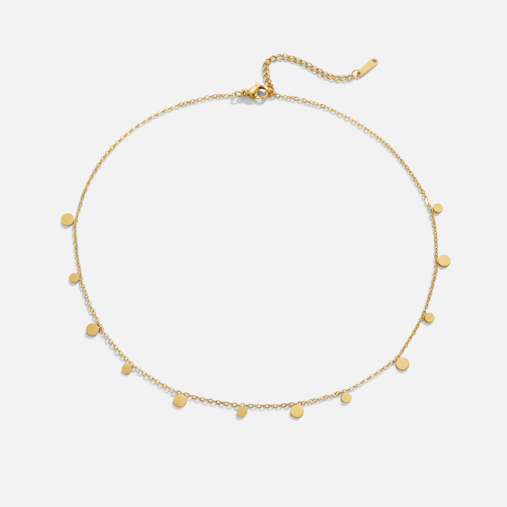 Agatha Gold Droplet Necklace, flat lay of a gold chain with small round discs and an extender