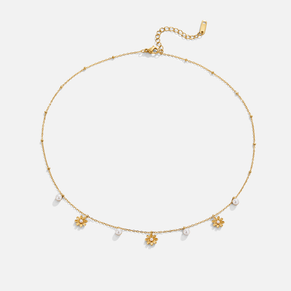 Autumn Flower & Pearl Necklace, flat lay of gold chain with flower and pearl charms along the front