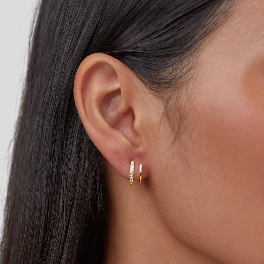 18K Gold & Crystal Claw Earrings, worn on an ear, one pavé-set hoop and one plain gold hoop