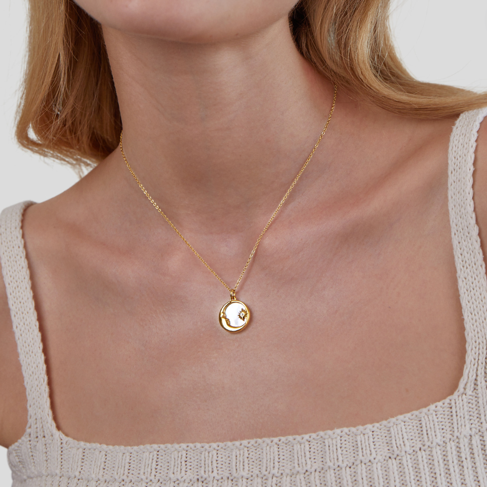 'Dreaming in the Clouds' Moon & Star Necklace, worn on a neck with a cream knit top, round