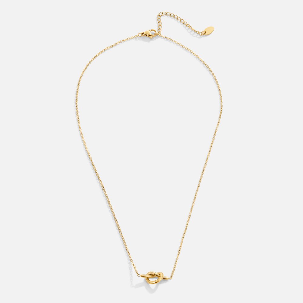 Adela Knot Necklace, flat lay on white, gold chain with a small knot pendant