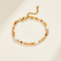 Agate & Pearl Bead Bracelet, laid flat on cream surface, orange agate beads with pearls and