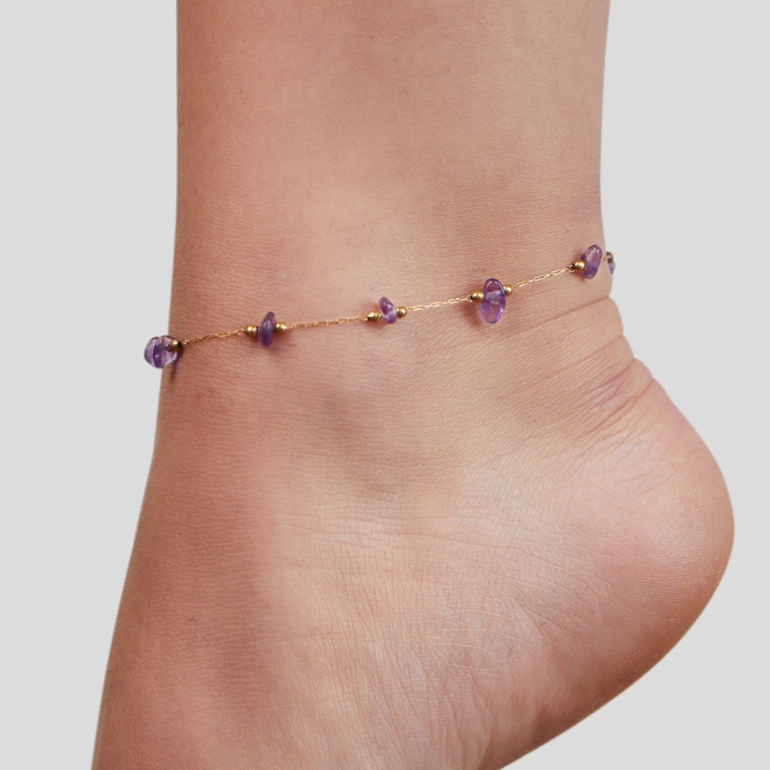 Amethyst Stone Anklet, worn on a bare ankle, purple stones on a gold chain