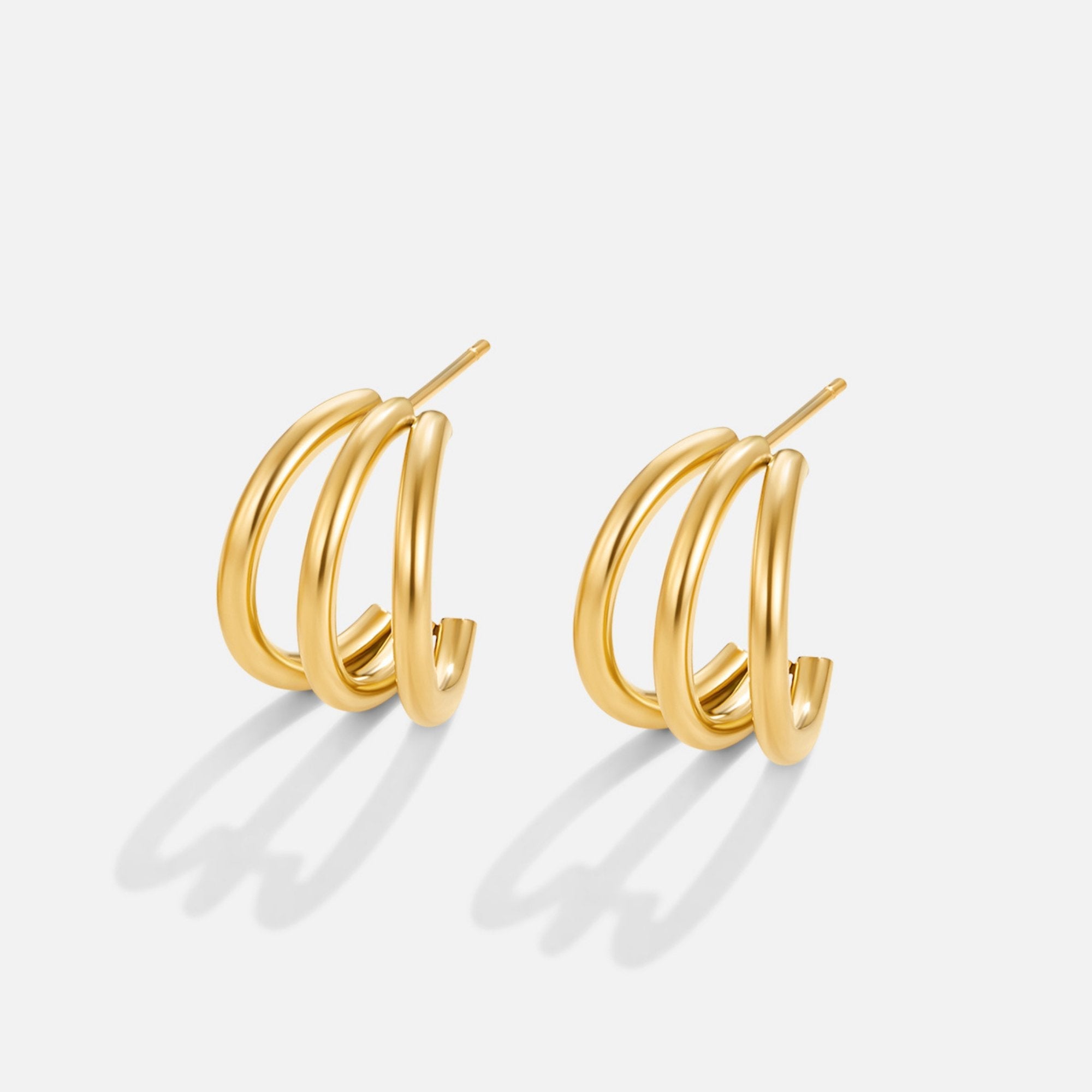 Anaya Triple Gold Hoop Earrings, pair of gold triple-hoop earrings on white background