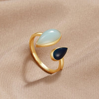 Aquamarine Teardrop Ring, gold open ring with pale blue and dark navy teardrop stones on beige