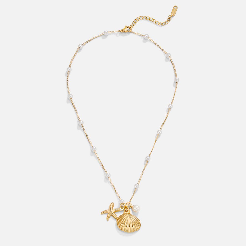 Aria Shell Charm Necklace, flat lay of a gold chain with pearls, starfish and scallop shell charms