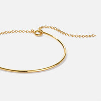 Aspen Gold Bracelet, close-up of a polished gold bangle with chain extender on white