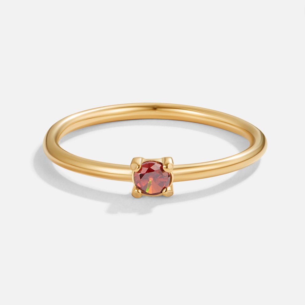 Birthstone 18K Gold Rings, standing alone on white, gold band with a small round red stone