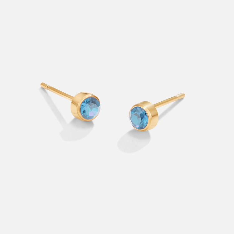 Birthstone Stud Earrings, pair of gold studs with round blue gems on white background