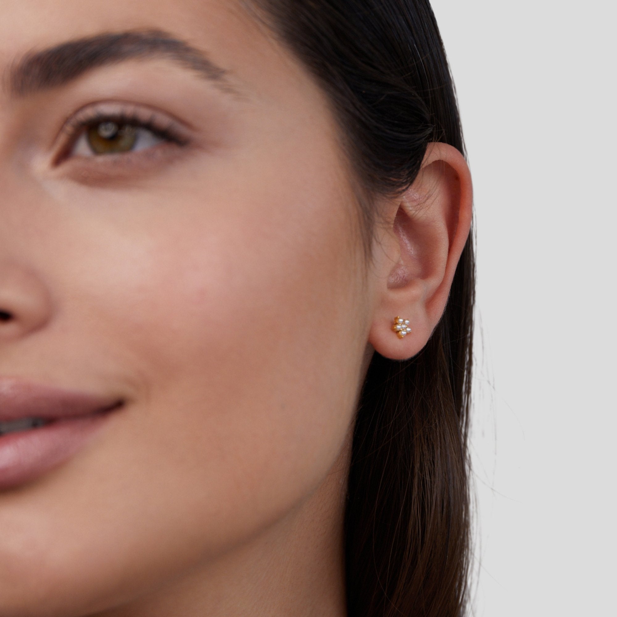 Blooming Flower Pearl Earrings, worn on an ear, close-up of a woman's face in profile