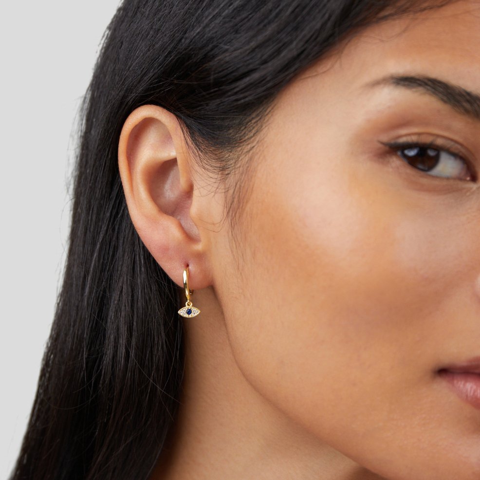 Blue Evil Eye Drop Earrings, worn in one ear, gold hoop with small evil eye charm