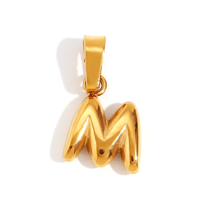 Bubble Letter Necklace, close-up of a glossy gold bubble letter M pendant on white