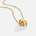 Camilla Pendant Necklace, gold chain with three stacked rings, green stones on one, on white