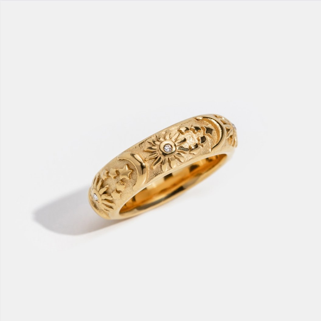 Celestial Gold Ring, standing alone on white, gold band with embossed suns, moons and stars