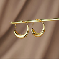 Classic Drop Hoop Earrings, pair of gold crescent hoop earrings hanging from a gold rod