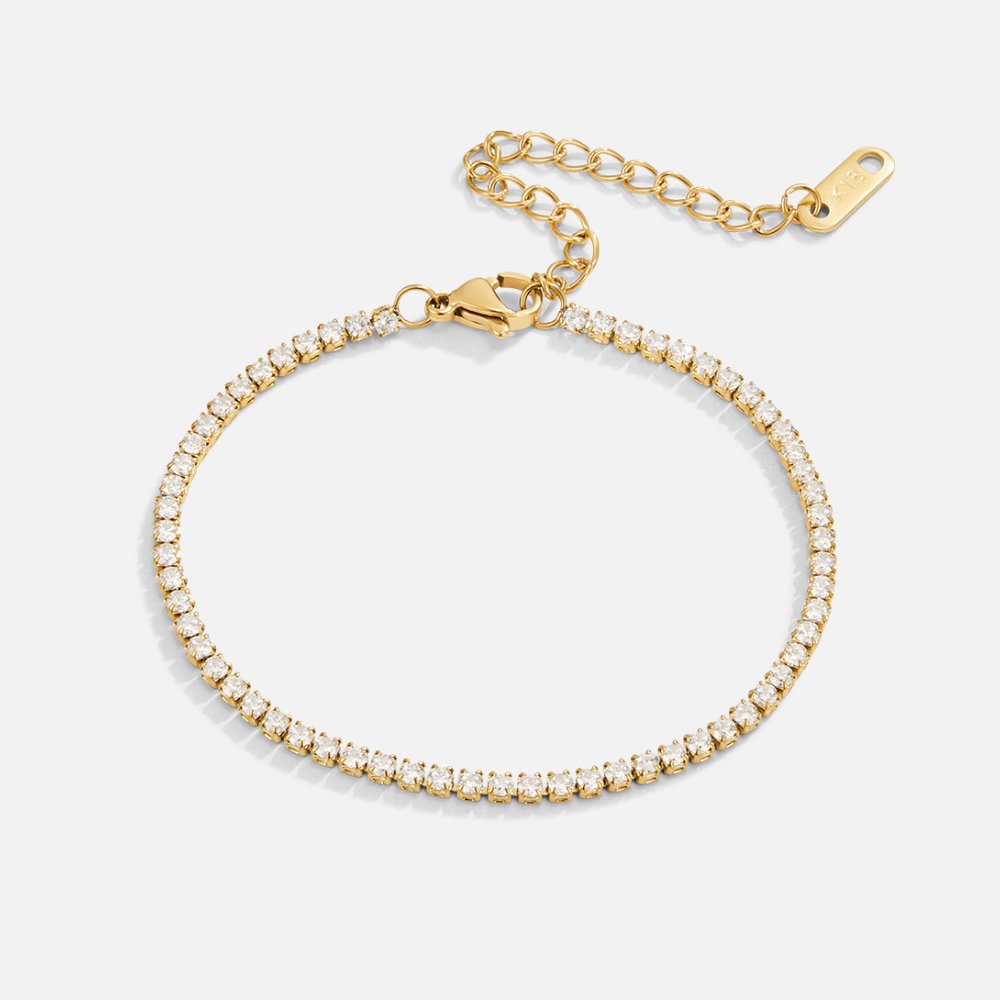 Cordelia Gold Tennis Bracelet, flat lay of gold bracelet with clear stones on white background